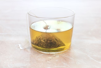 clear drinking glass with yellow liquid