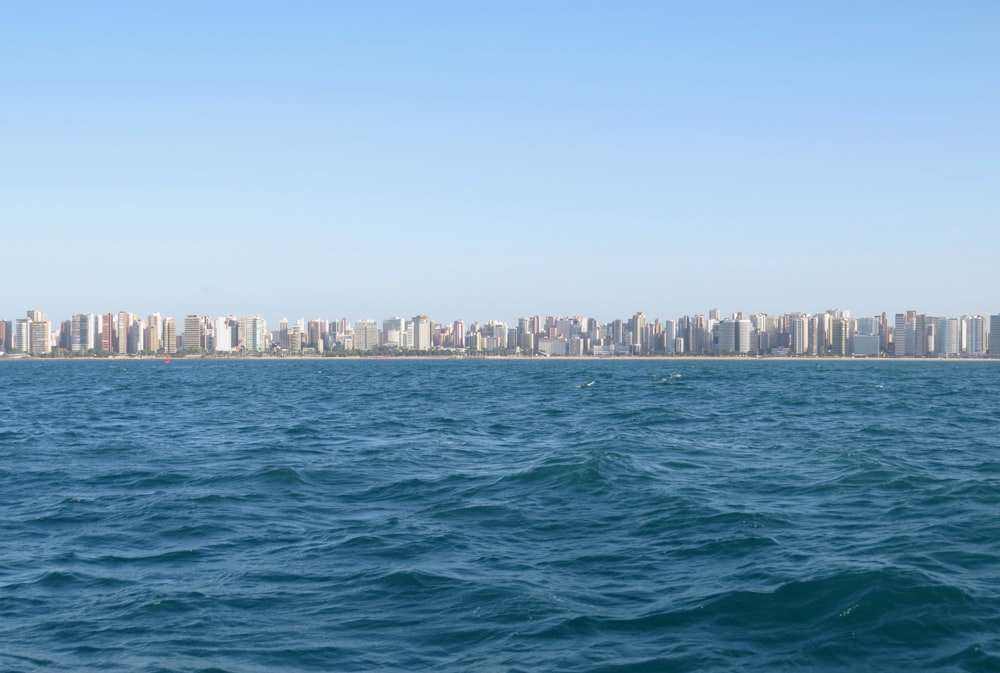 a large body of water with a city in the background