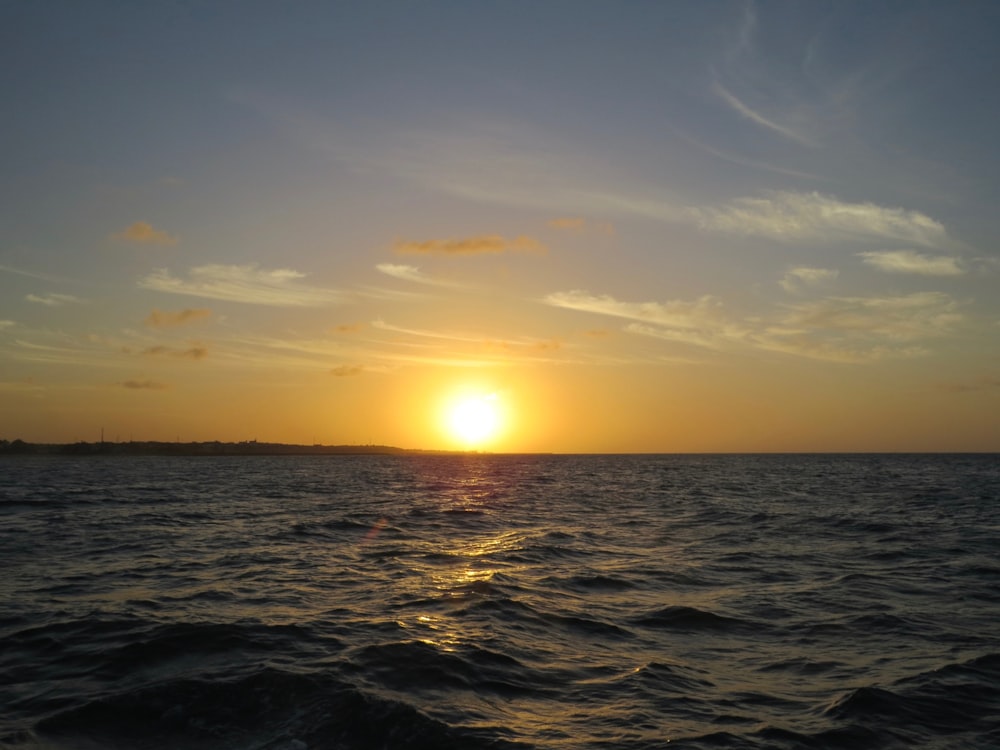 body of water during sunset