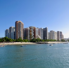 city buildings near sea under blue sky during daytime