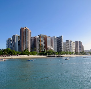 city buildings near sea under blue sky during daytime