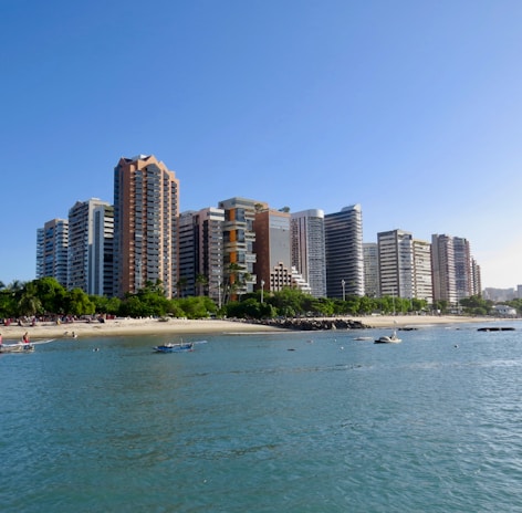 city buildings near sea under blue sky during daytime