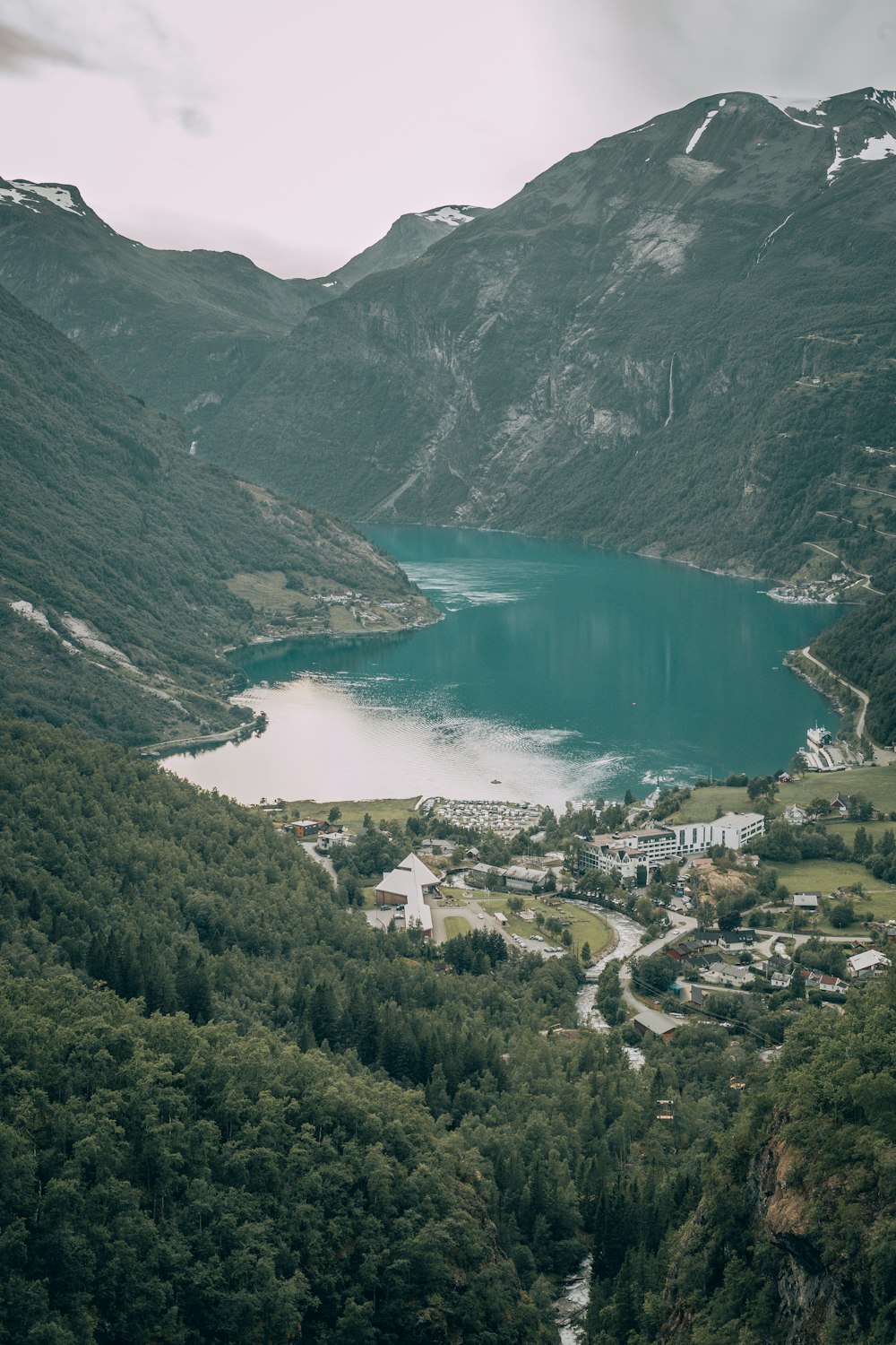 aerial view of green mountains and lake