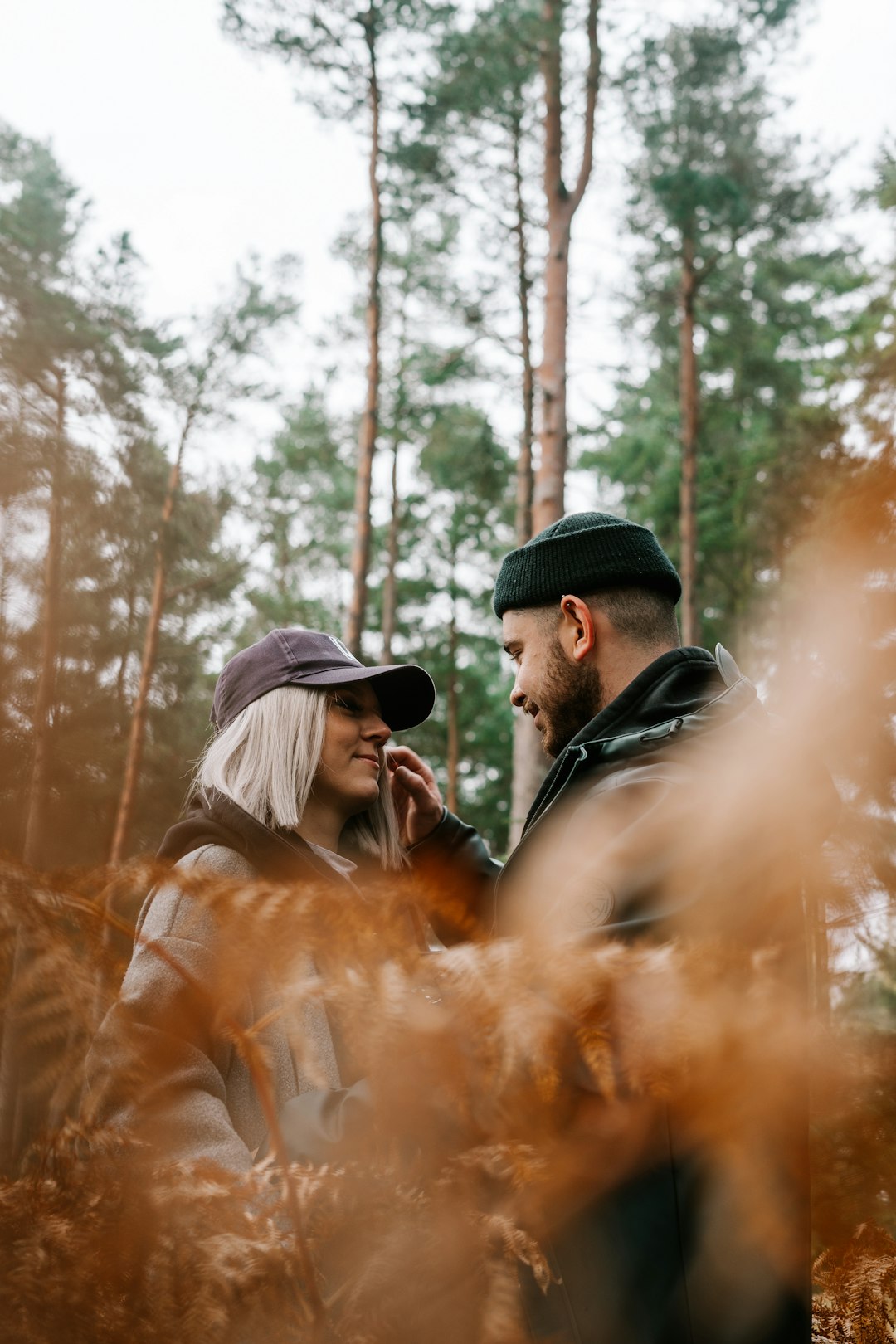 man in black knit cap and brown jacket