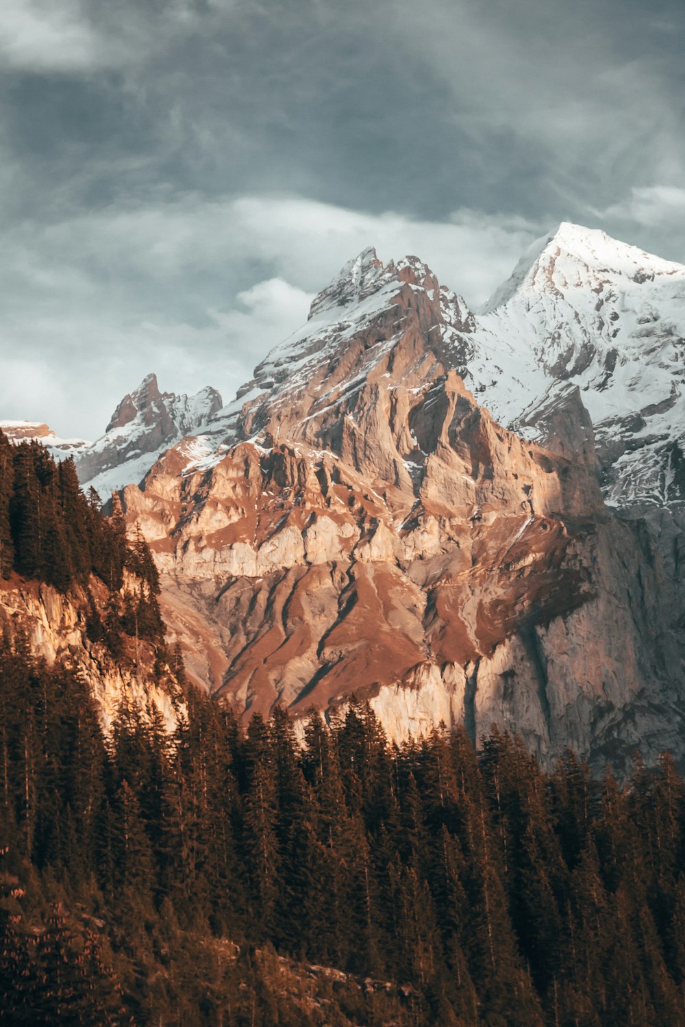 brown and white mountain under white clouds during daytime