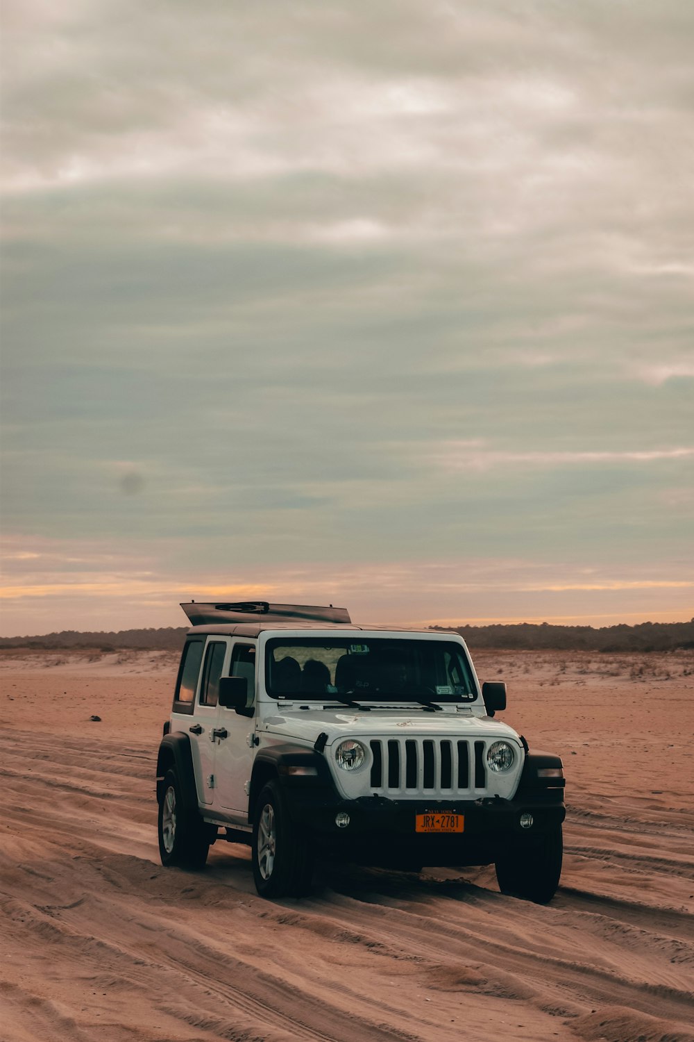 white jeep wrangler on brown field during daytime