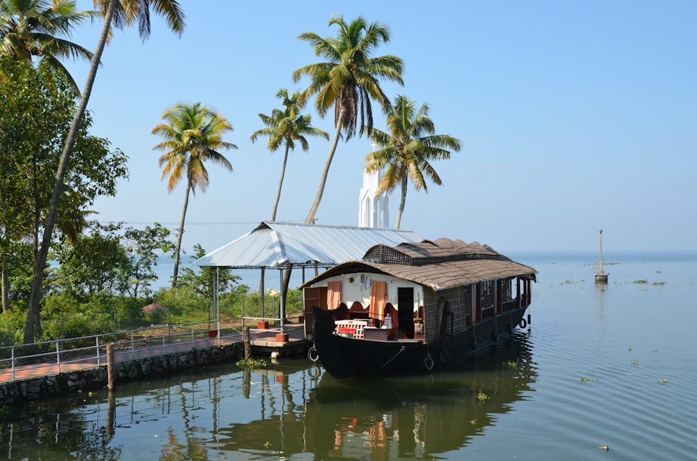 brown wooden boat on body of water during daytime