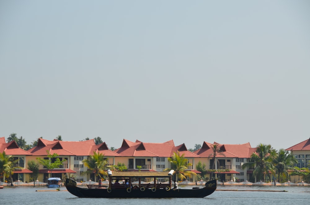 boat on water near houses during daytime