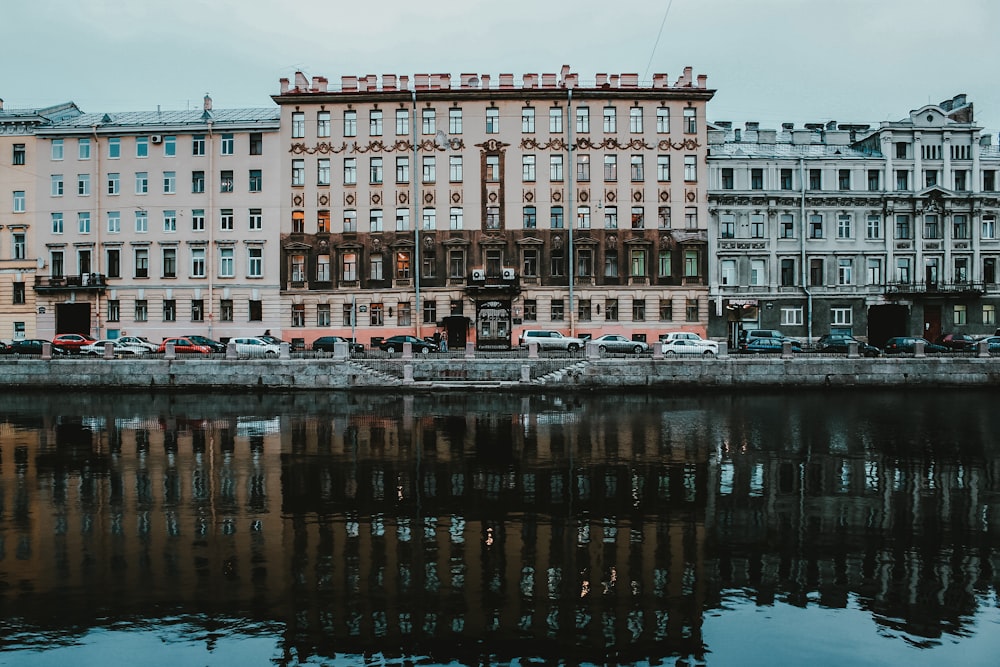 brown concrete building near body of water during daytime