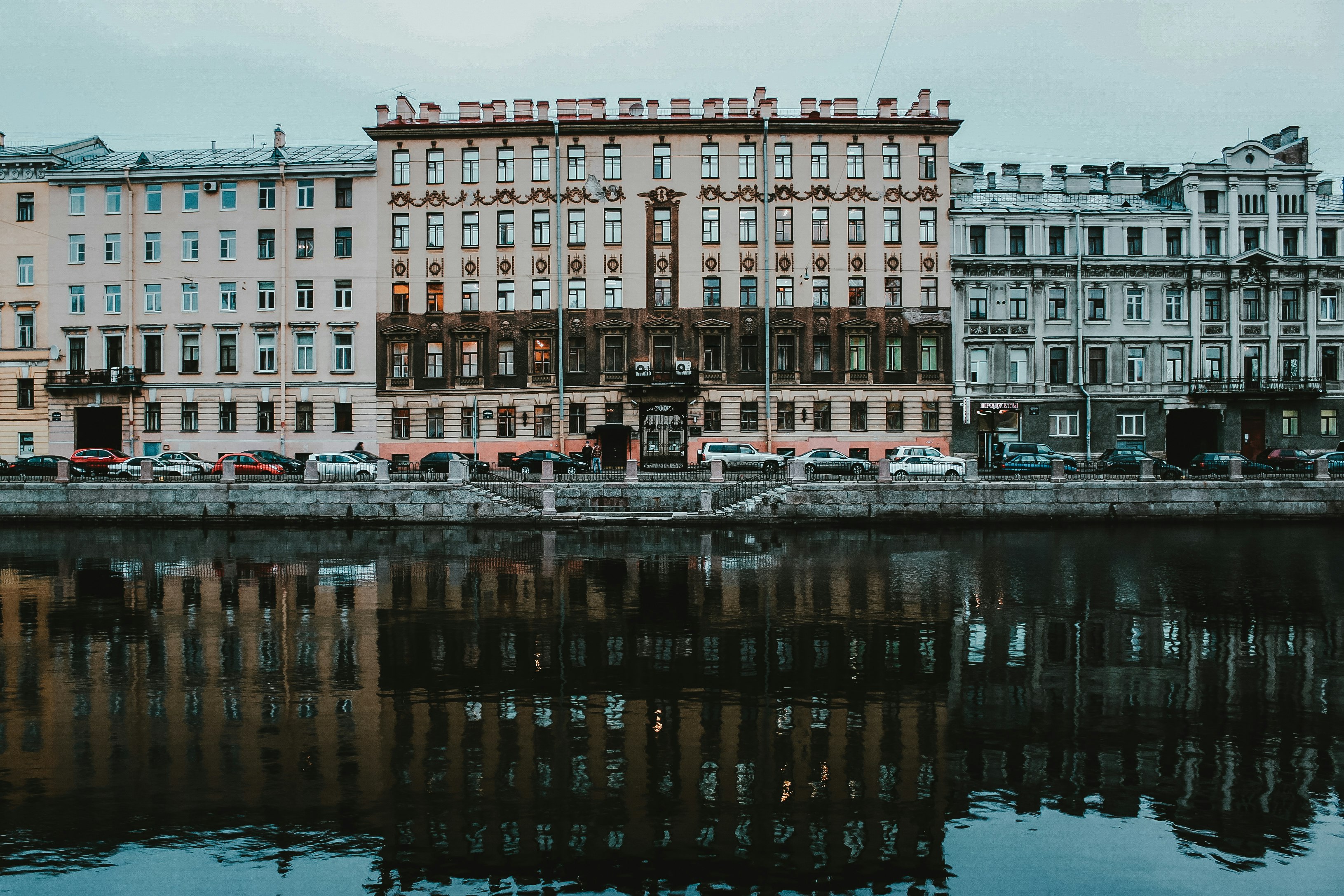 brown concrete building near body of water during daytime