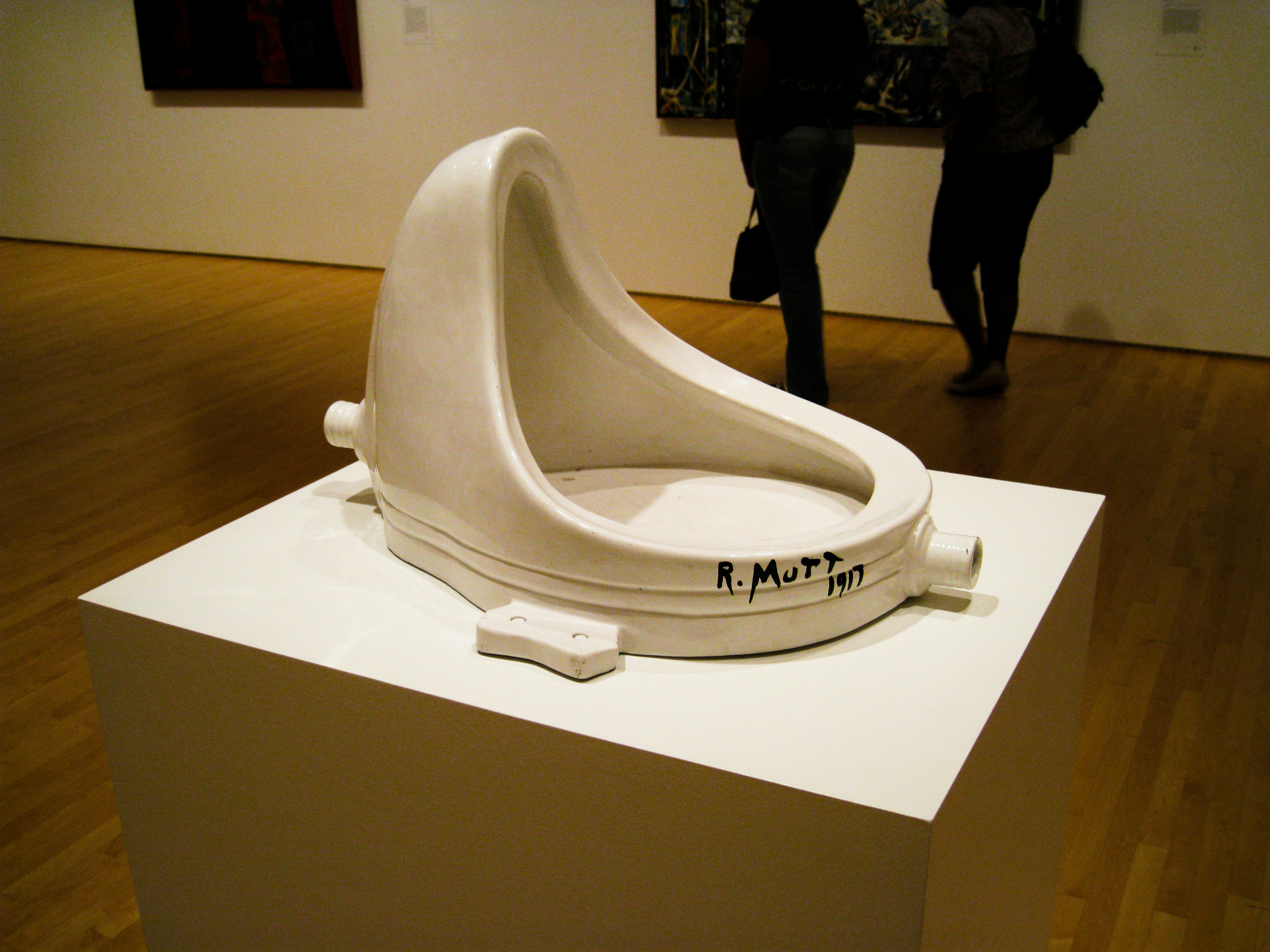 A sleek white bidet toilet seat in a modern bathroom