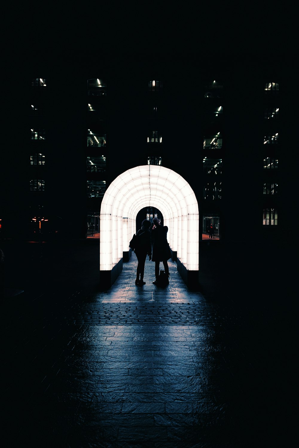 silhouette of person walking on tunnel