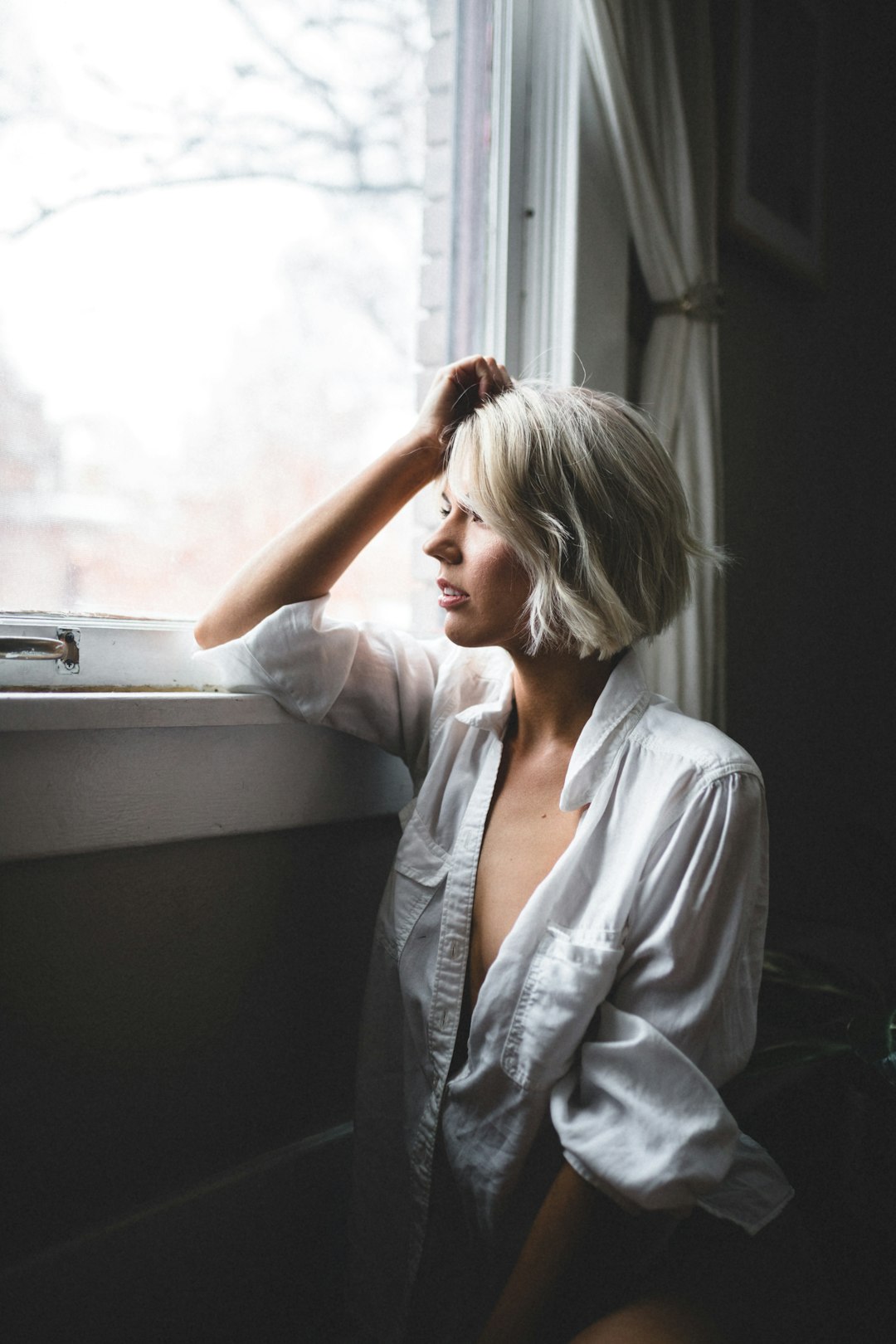 woman in blue button up shirt sitting on white chair