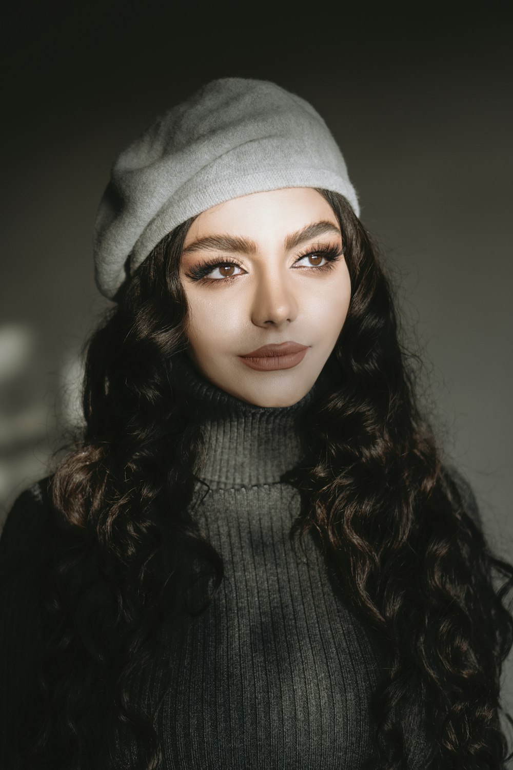 woman in gray knit cap and black coat