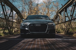 a black car is parked on a bridge