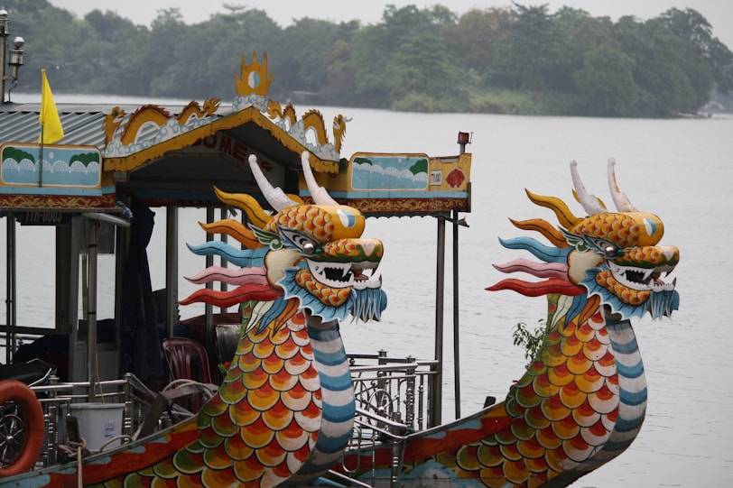 Ha Long Bay's Limestone Karsts yellow and blue dragon on brown wooden boat