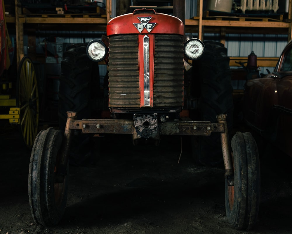 red and black tractor in garage