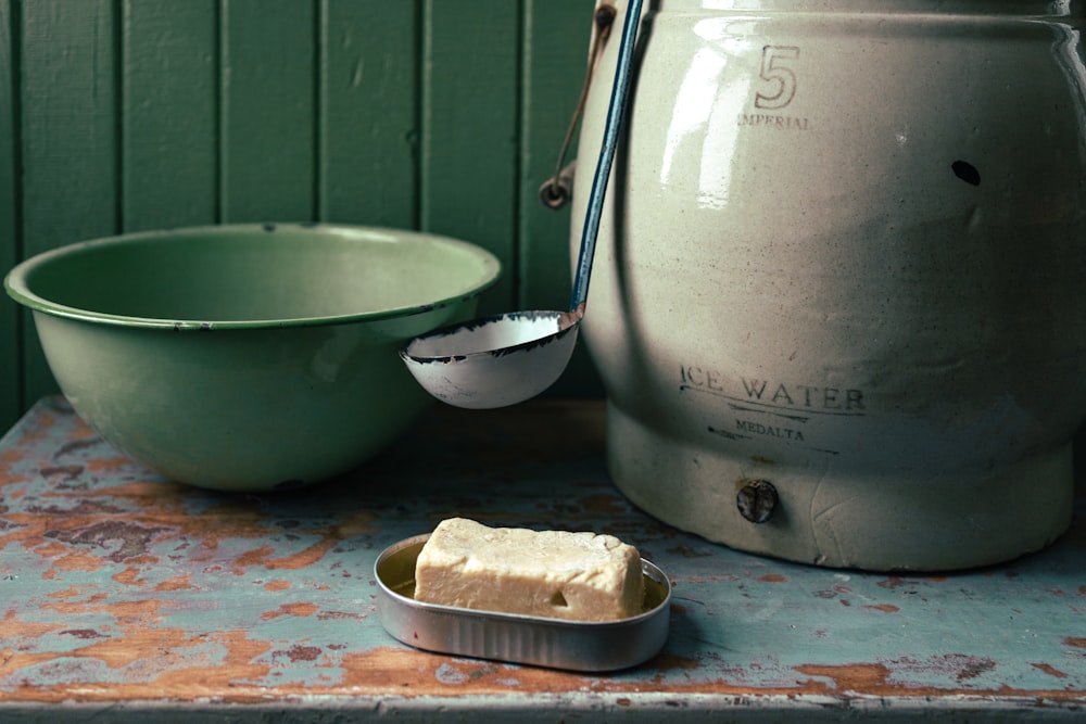 stainless steel cooking pot beside white ceramic bowl