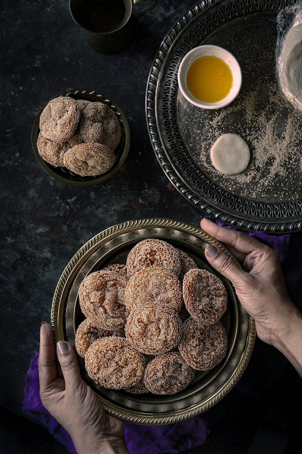 person holding brown round cookies