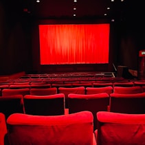 red chairs in a room by Merch HÜSEY (https://unsplash.com/@merchusey)