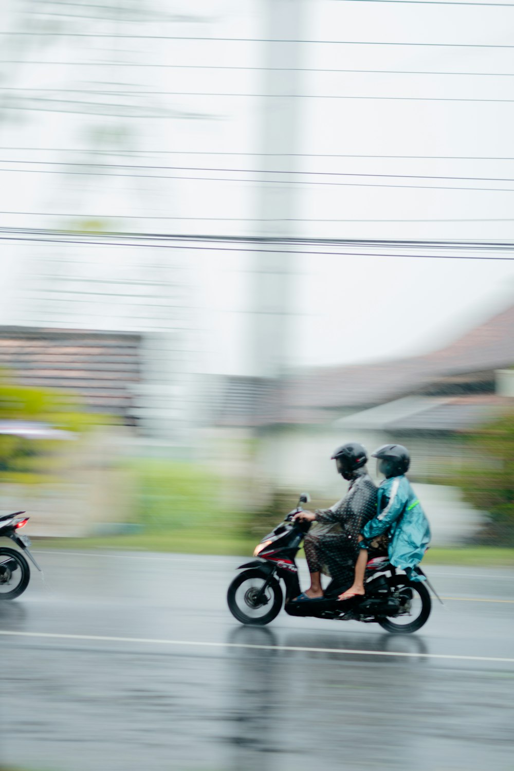 man and woman riding motorcycle on road during daytime