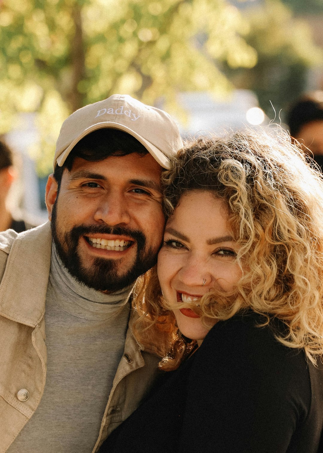 man in black crew neck shirt beside woman in gray coat