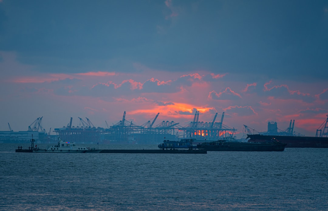 silhouette of ship on sea during sunset