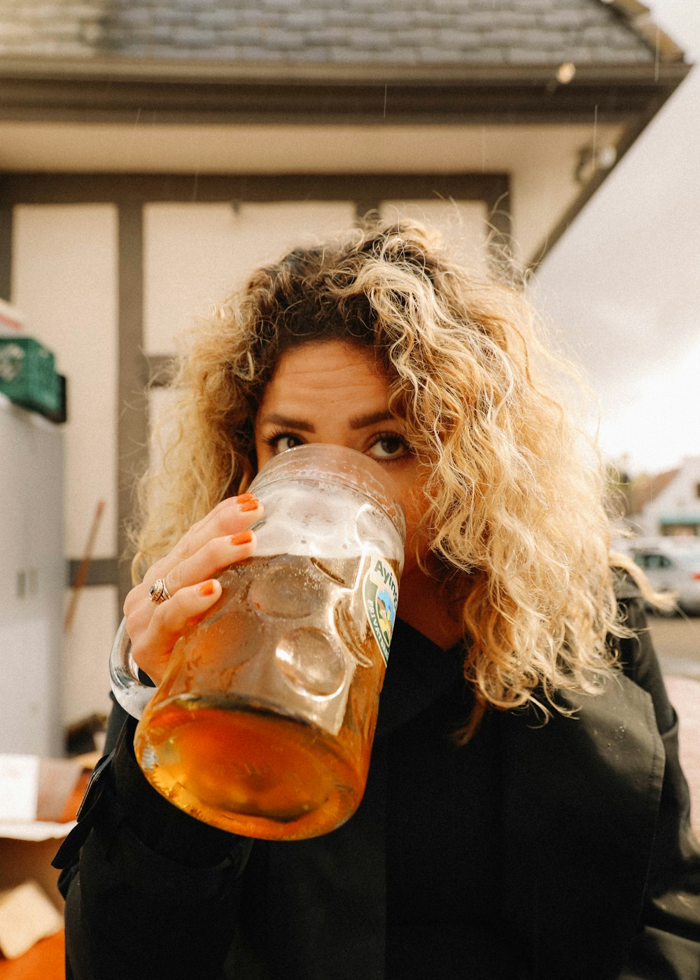 woman drinking from clear glass mug