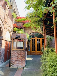 A warm, welcoming shelter entrance surrounded by greenery and flowers.