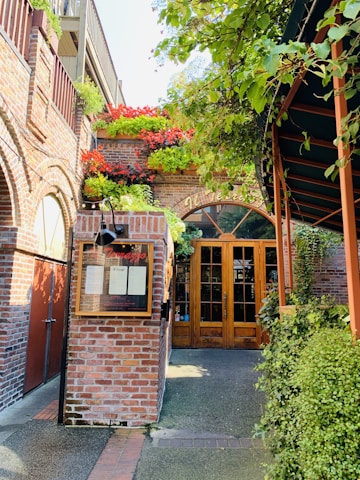 A warm, welcoming shelter entrance surrounded by greenery and flowers.