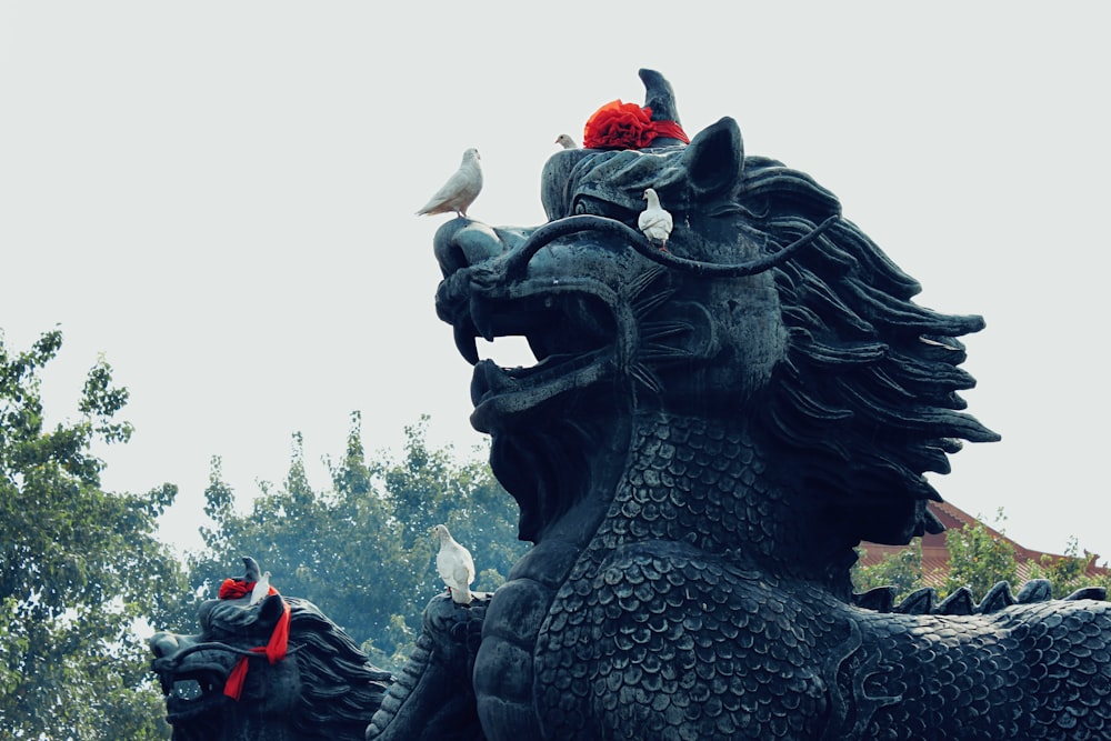 black dragon statue under white sky during daytime