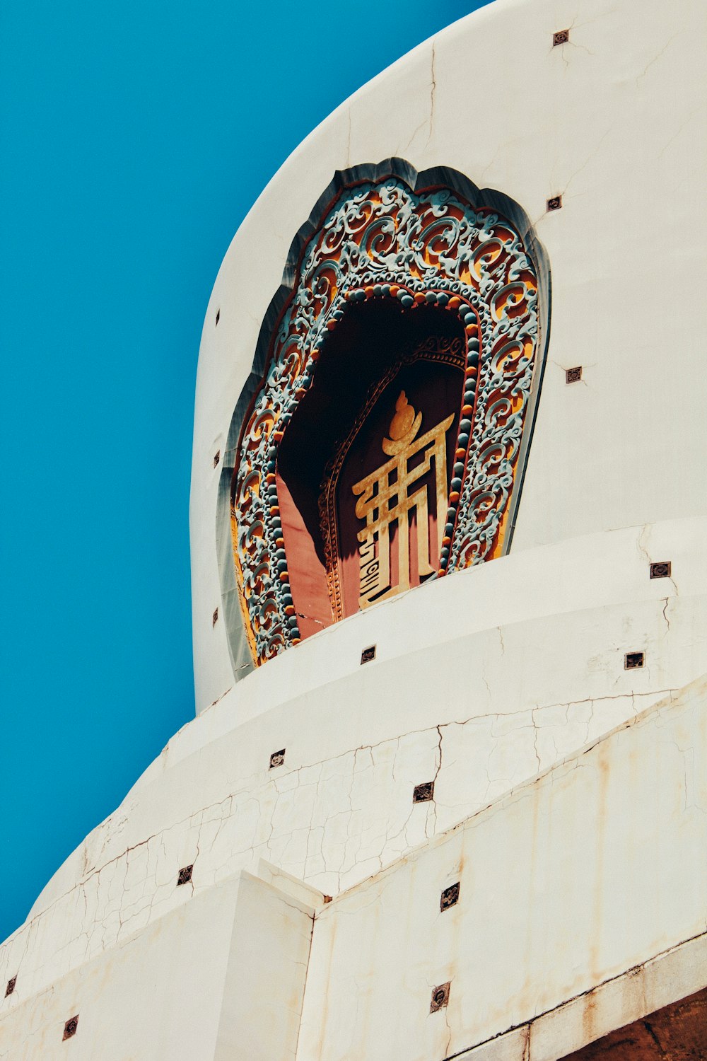 white and gold concrete building under blue sky during daytime