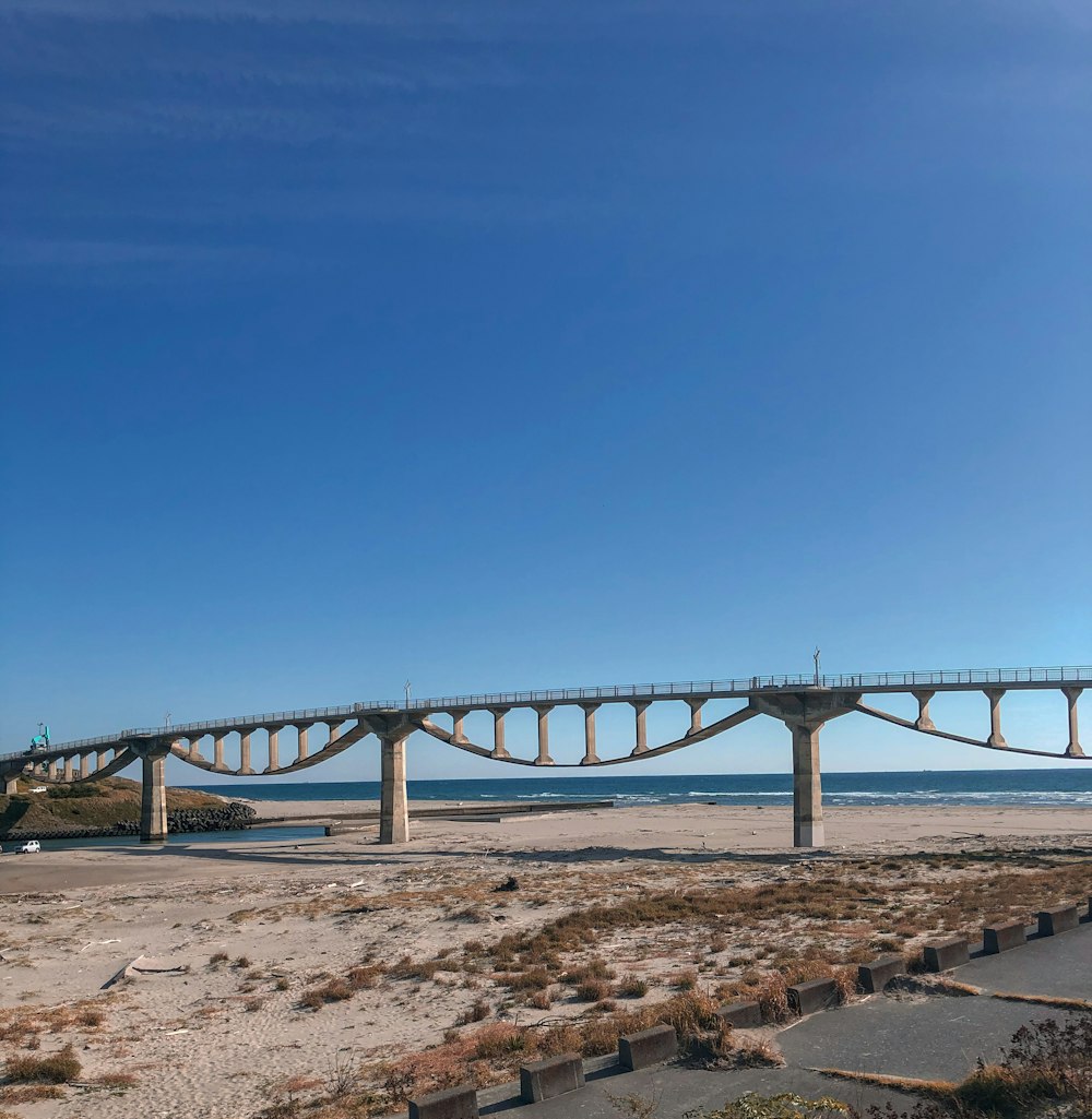 gray metal bridge under blue sky during daytime