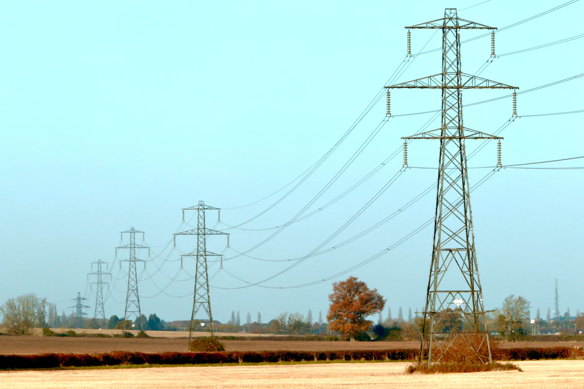 Electrical transmission towers carrying high-voltage lines across the Kenyan landscape