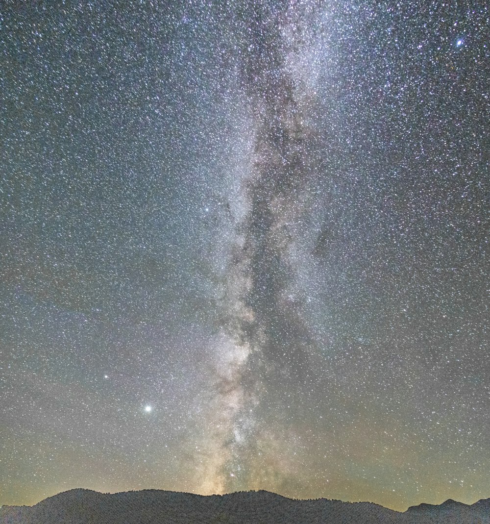 silhouette of mountain under starry night