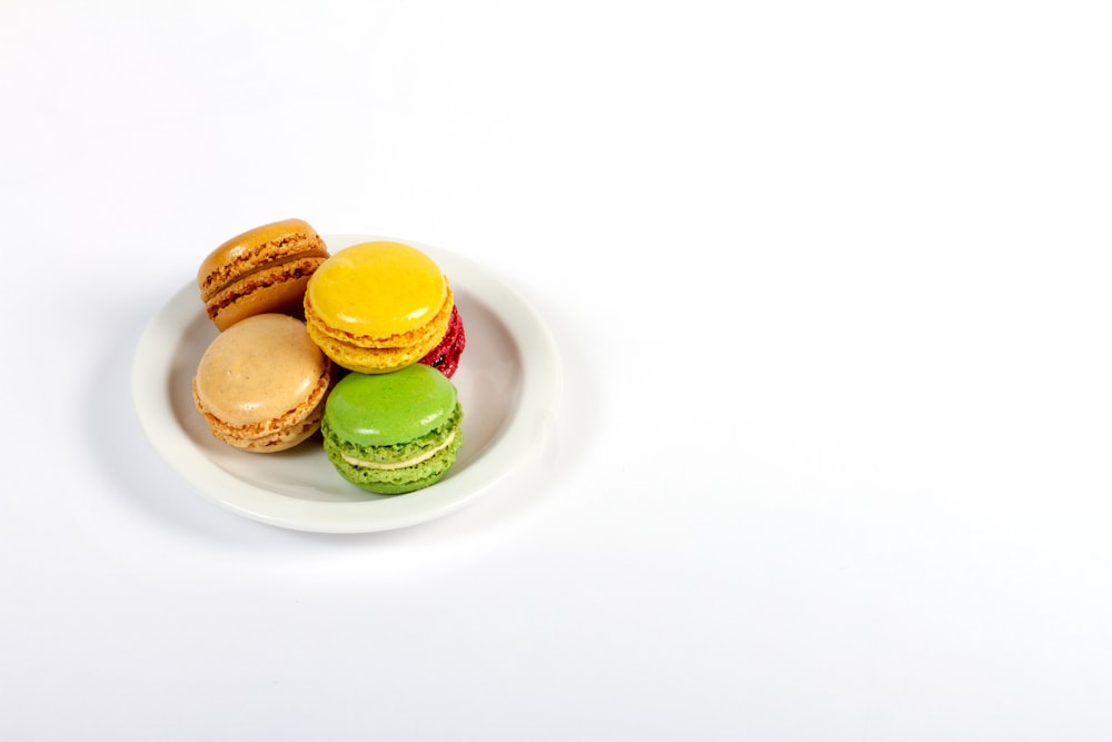 green yellow and brown macaroons on white ceramic plate