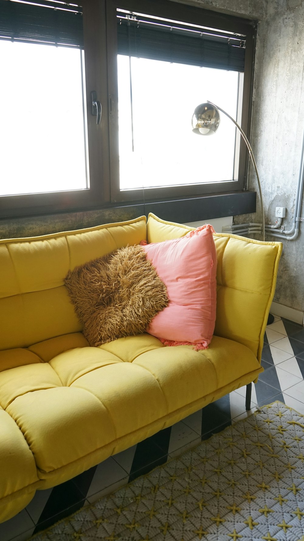 brown throw pillow on yellow couch