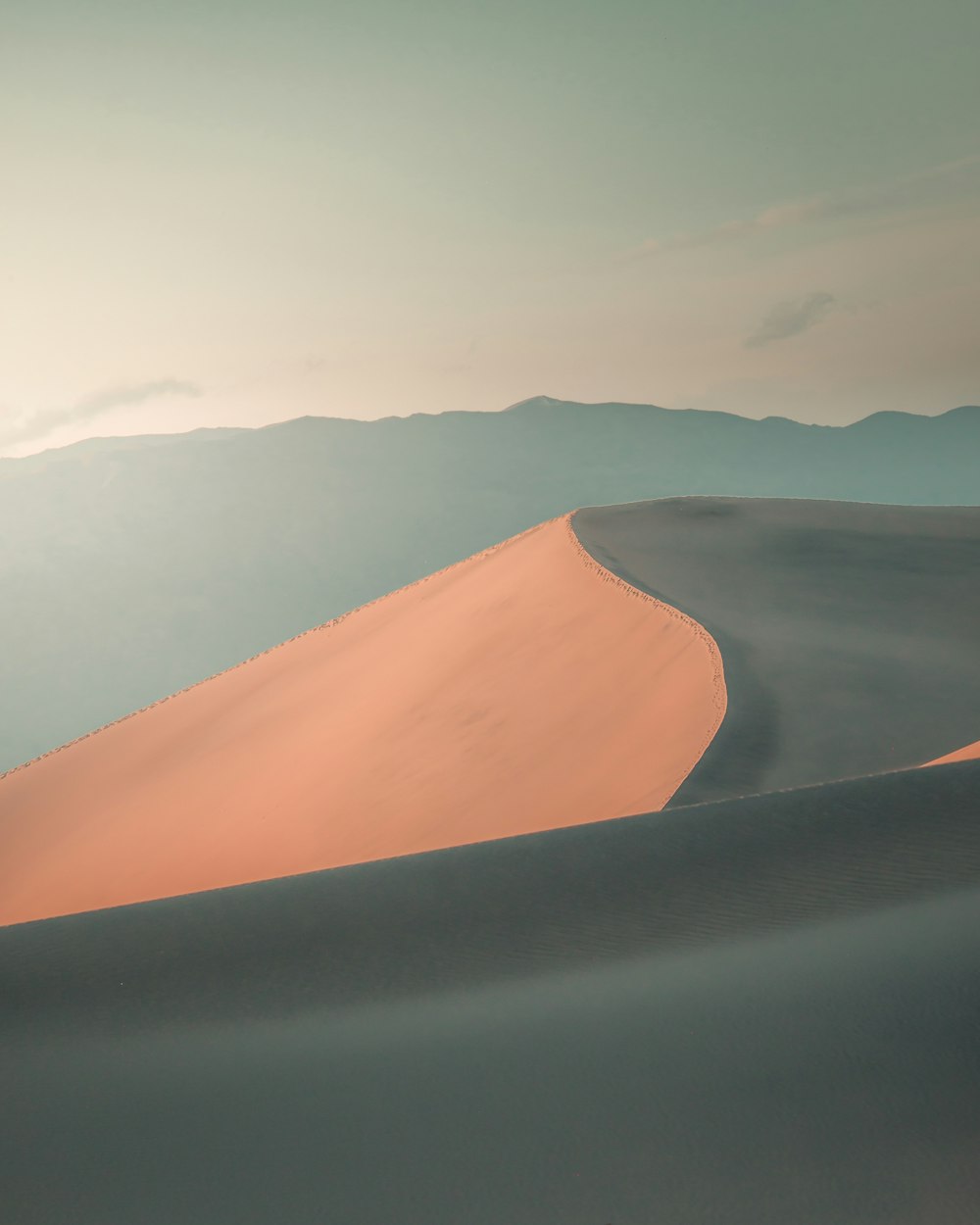 brown sand under white sky during daytime