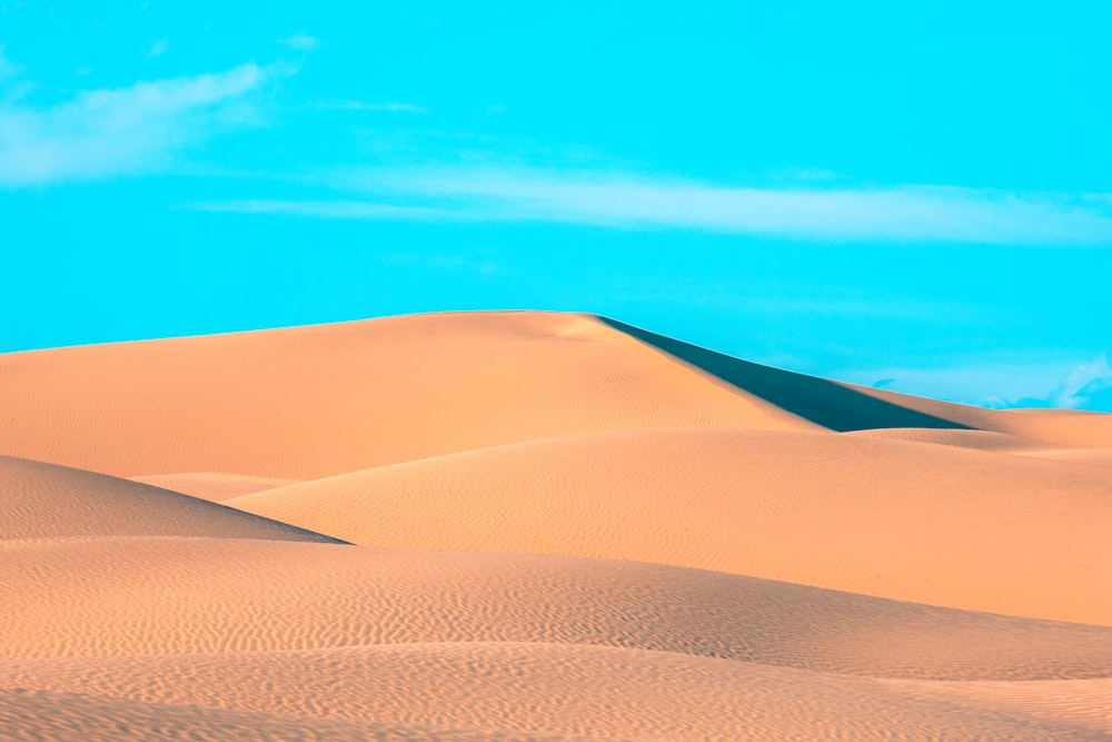 brown sand under blue sky during daytime