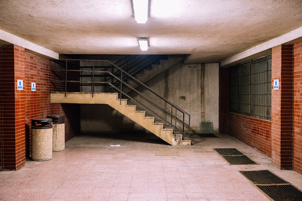 brown concrete staircase with stainless steel railings