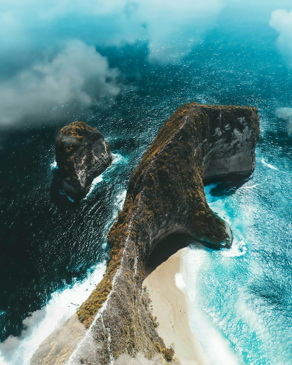 brown rock formation on body of water during daytime