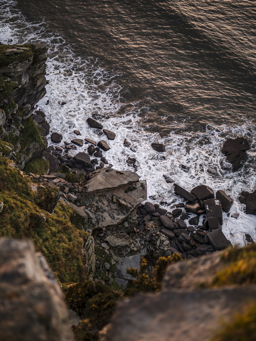 rocky shore with rocky shore during daytime