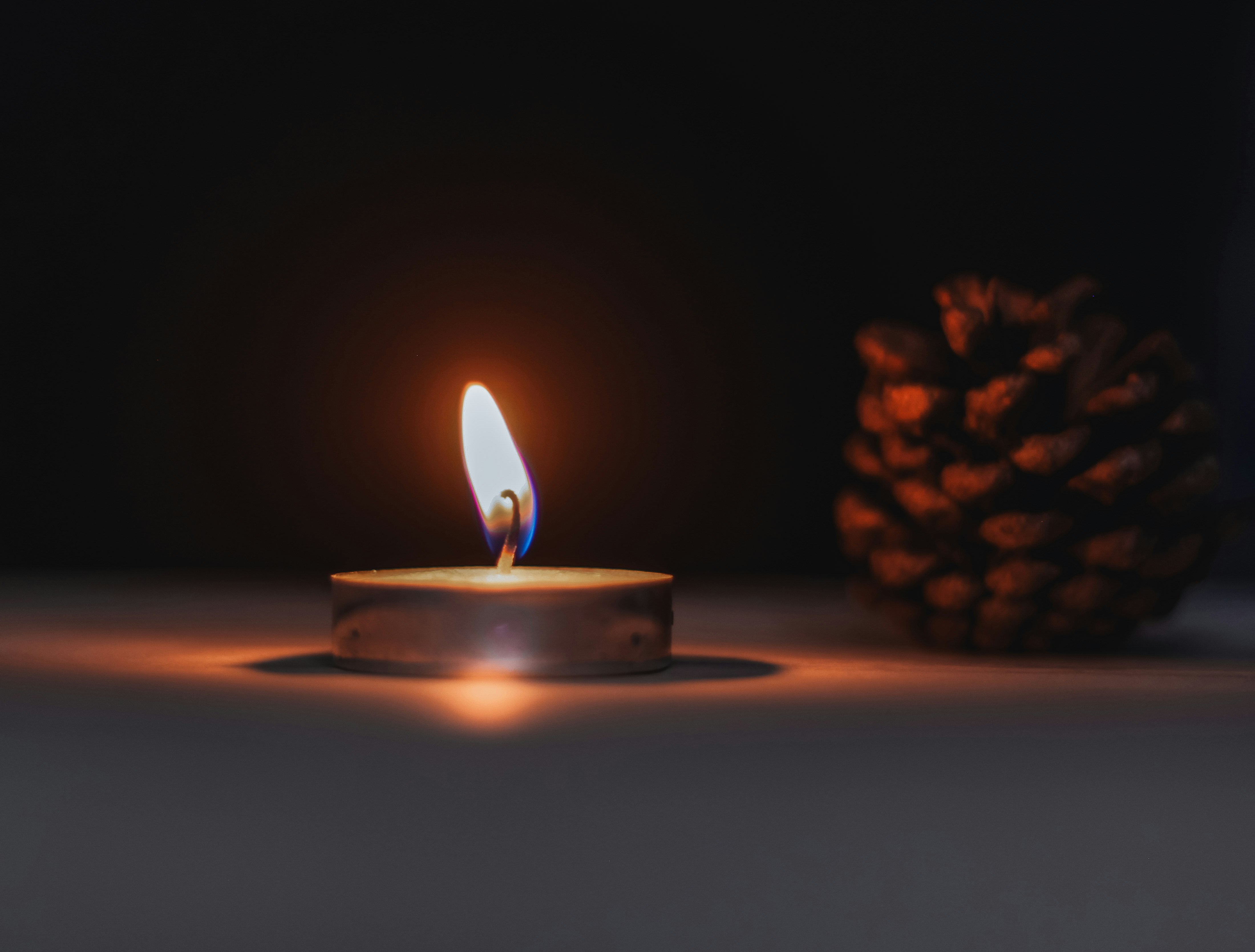lighted candle on brown wooden table