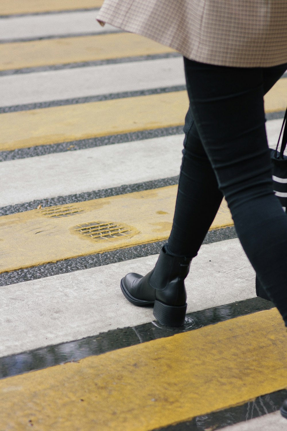 person in black pants and black leather shoes