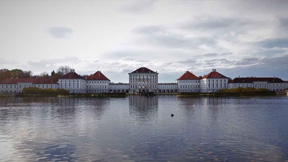 white and brown concrete building near body of water during daytime