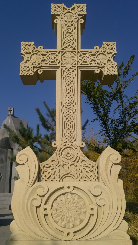 white concrete cross statue during daytime in Yerevan Armenia