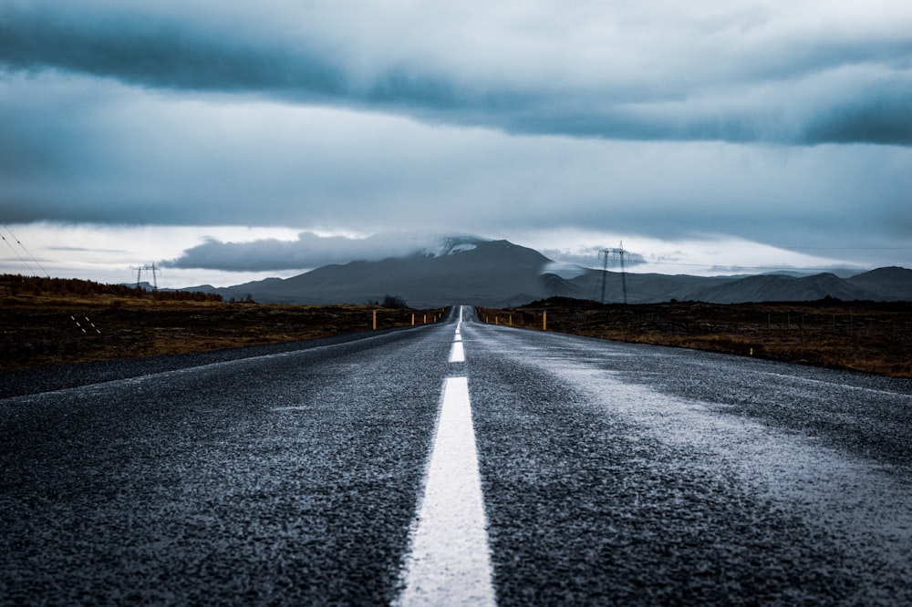 gray asphalt road under gray cloudy sky during daytime