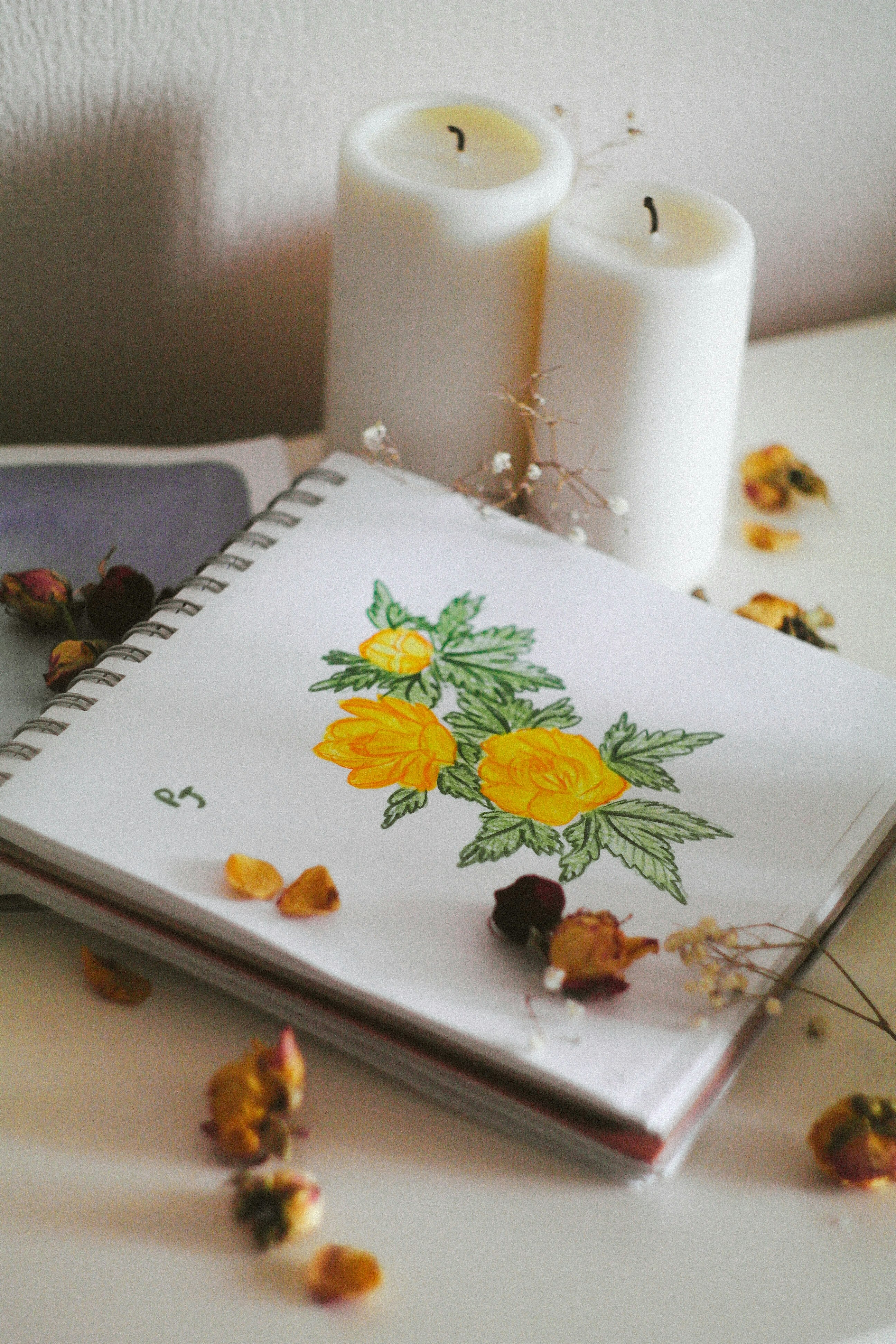 yellow and white flower on white notebook