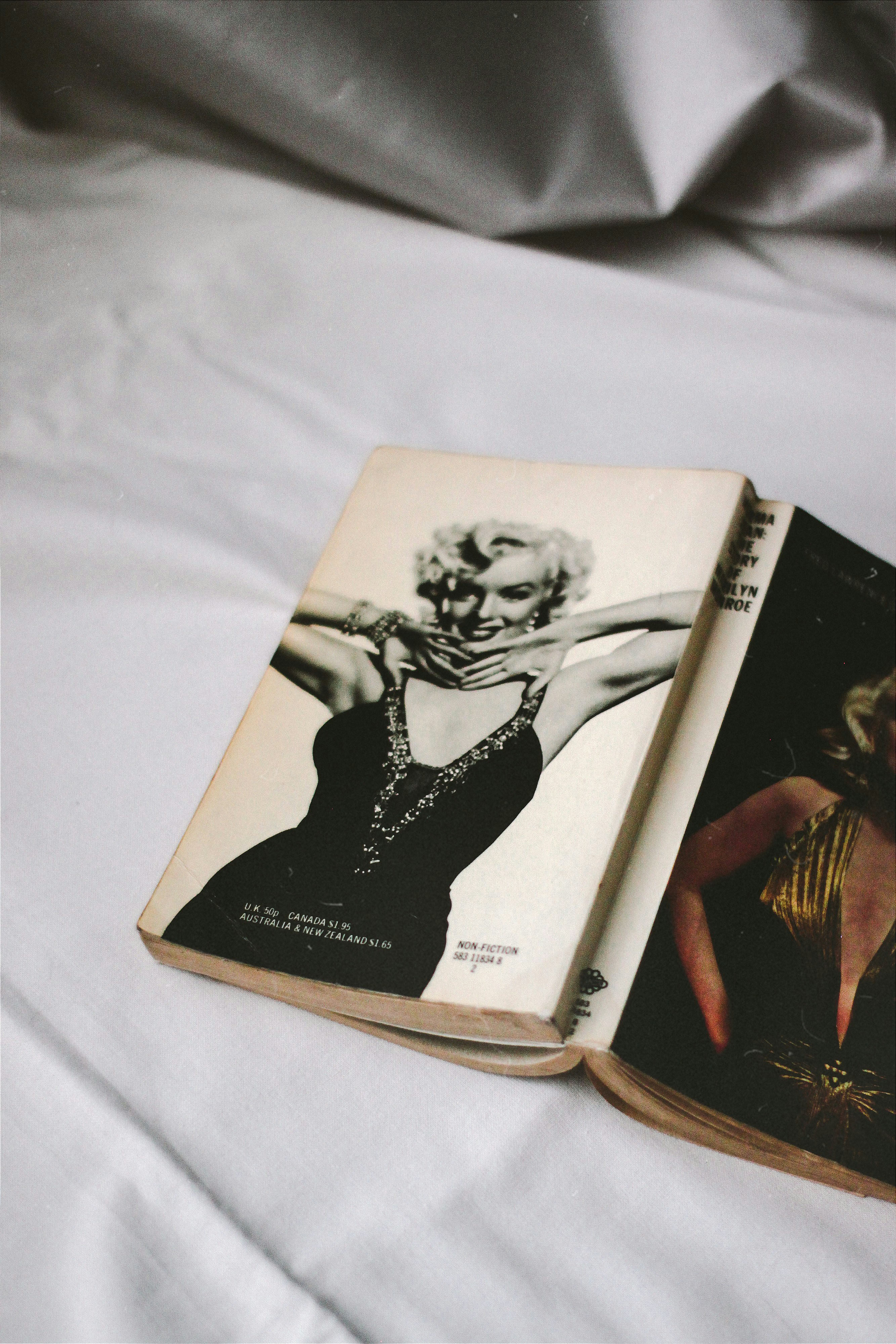 black and white book on white textile