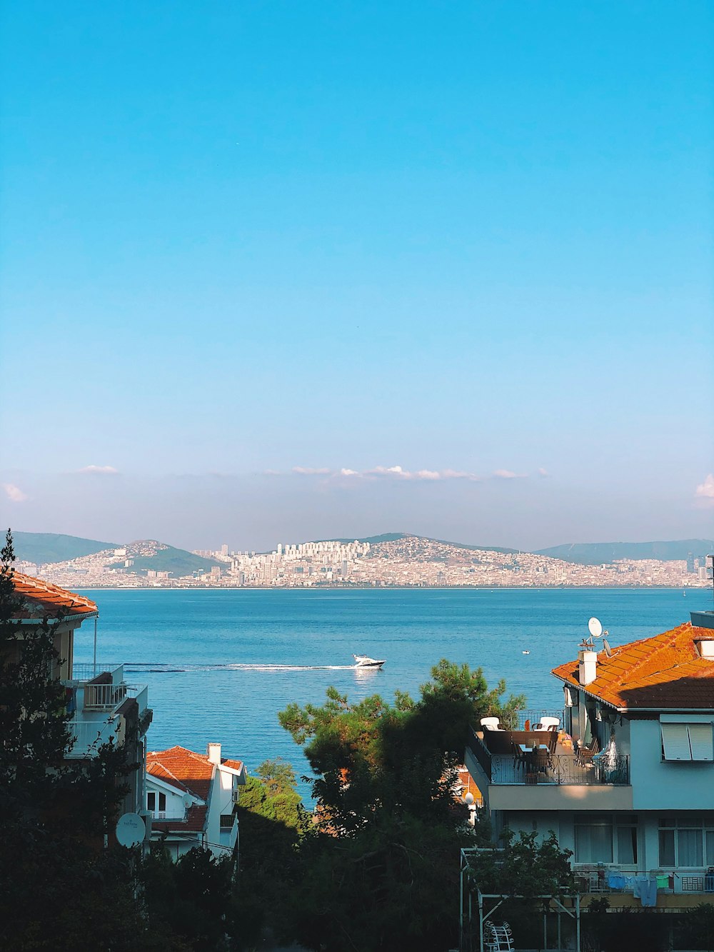 white and brown concrete building near body of water during daytime